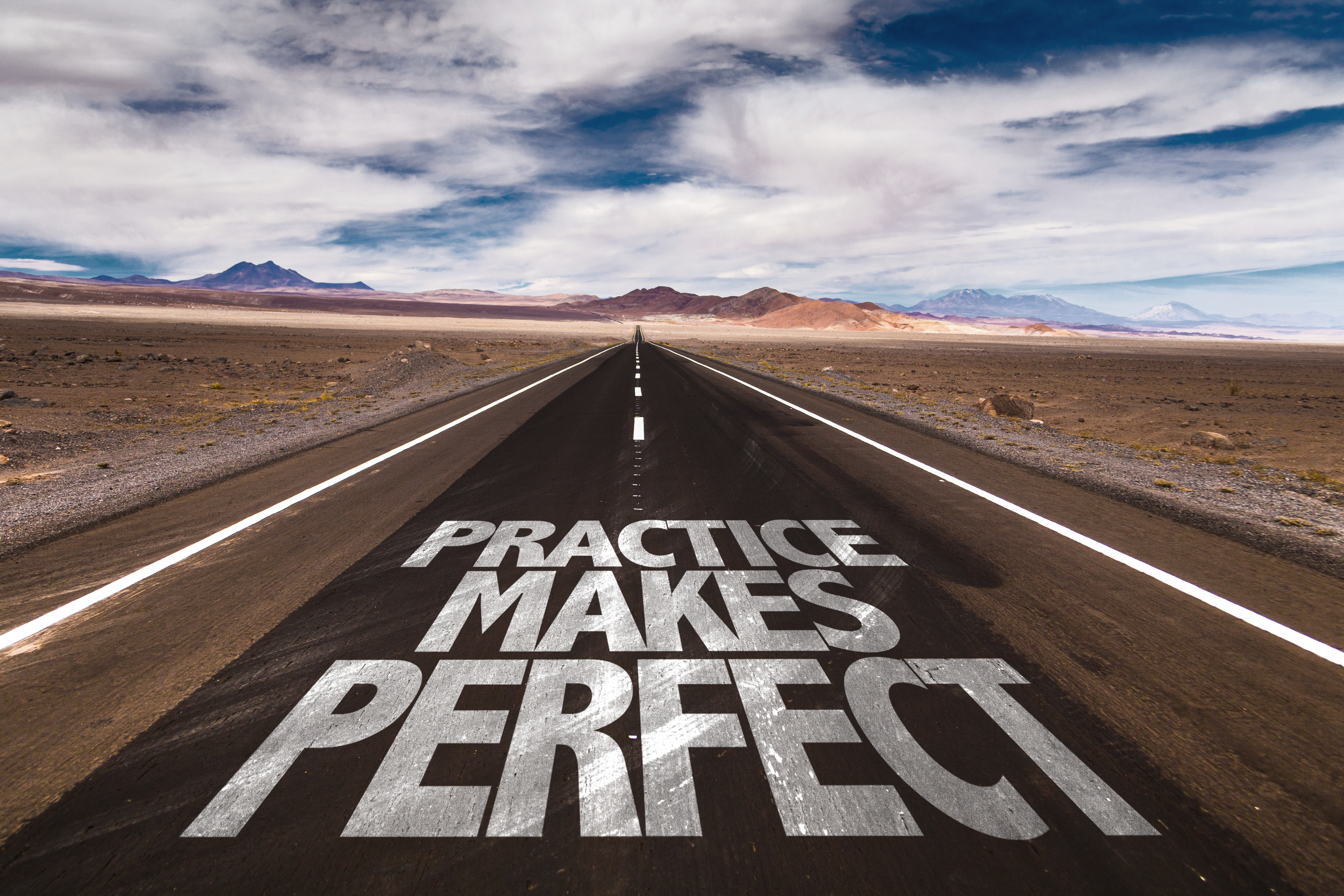 Practice Makes Perfect written on desert road
