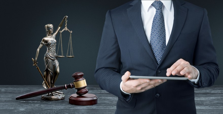 Lawyer with justice sign in background.jpeg