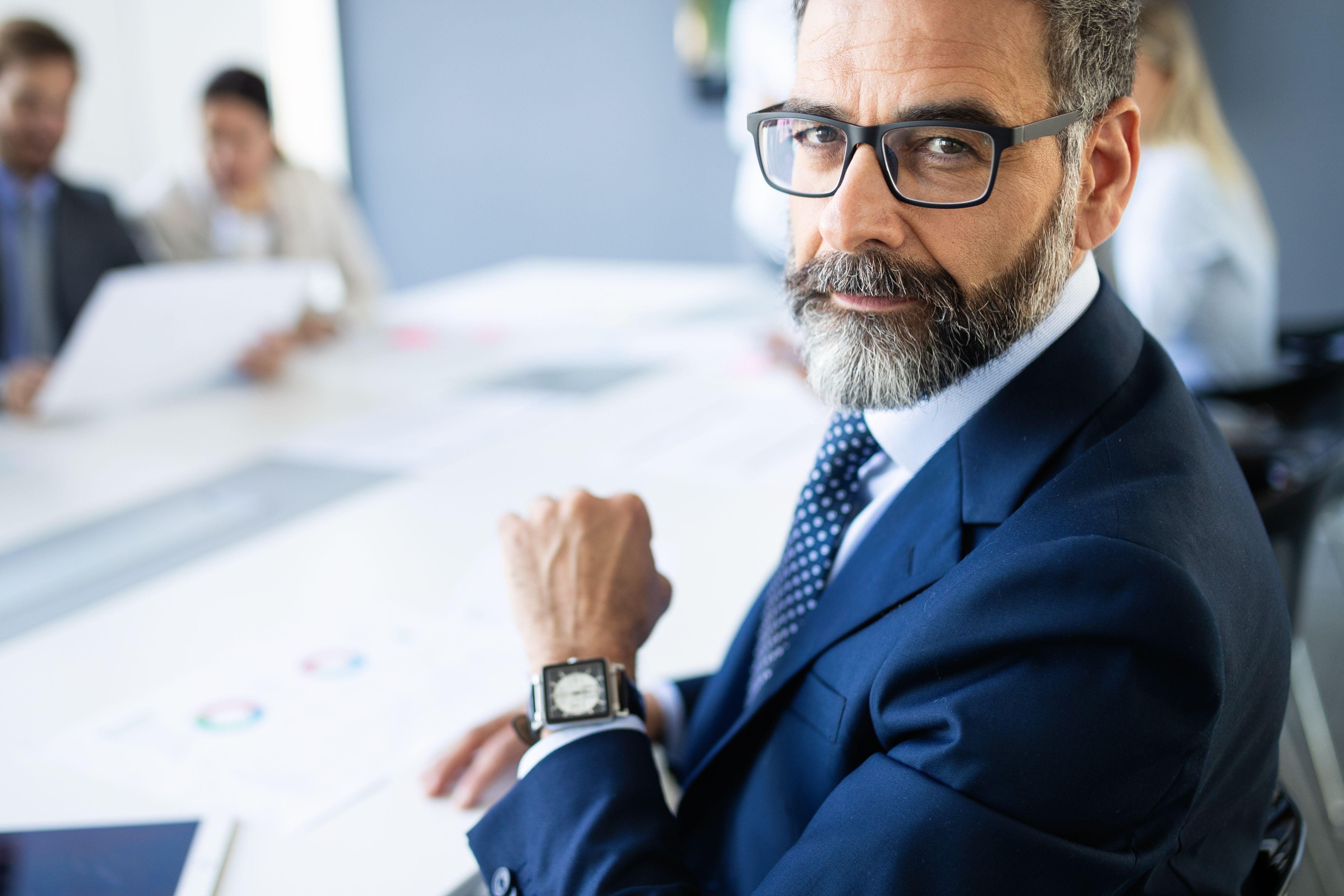 Shot of thinking financial advisor businessman working in office.